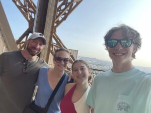 family at the Eiffel Tower taking a selfie. 