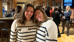 two women in white and black striped shirts