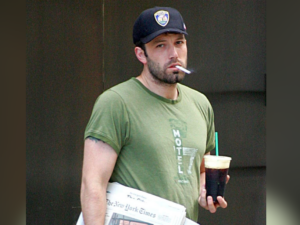 man with baseball hat, coffee and cigarette
