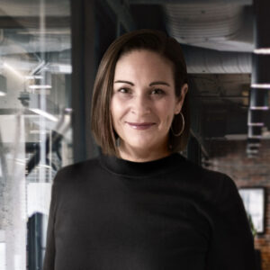 woman with short brown hair standing in an offfice