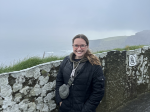 woman standing by the cloudy Cliffs of Moher