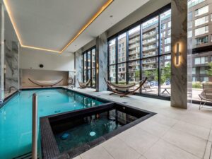 lavish indoor hotel pool with hot tub and hammocks