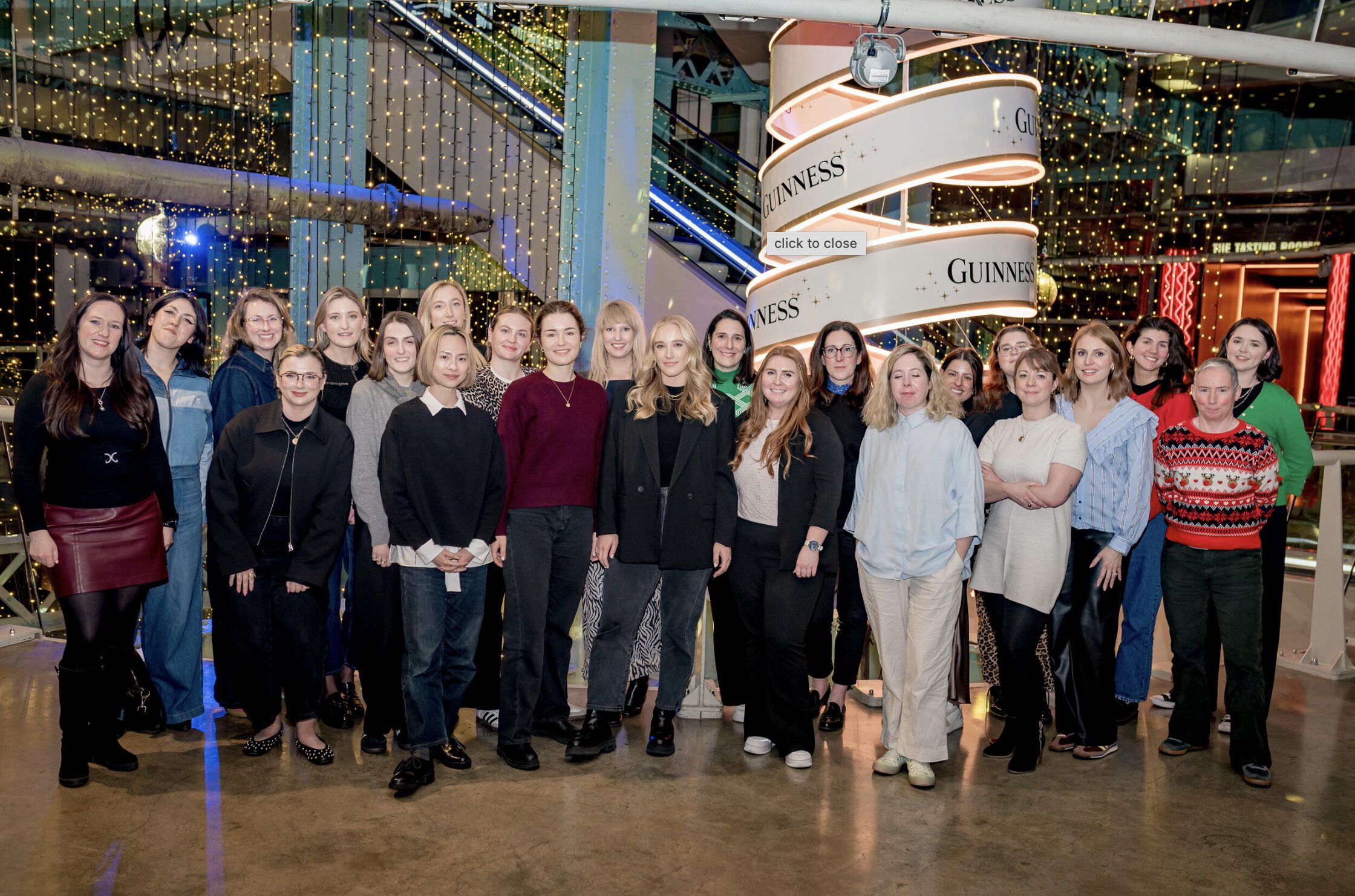 group of women posing in front of christmas decor