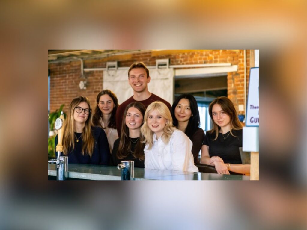 group of young adults in a brick office