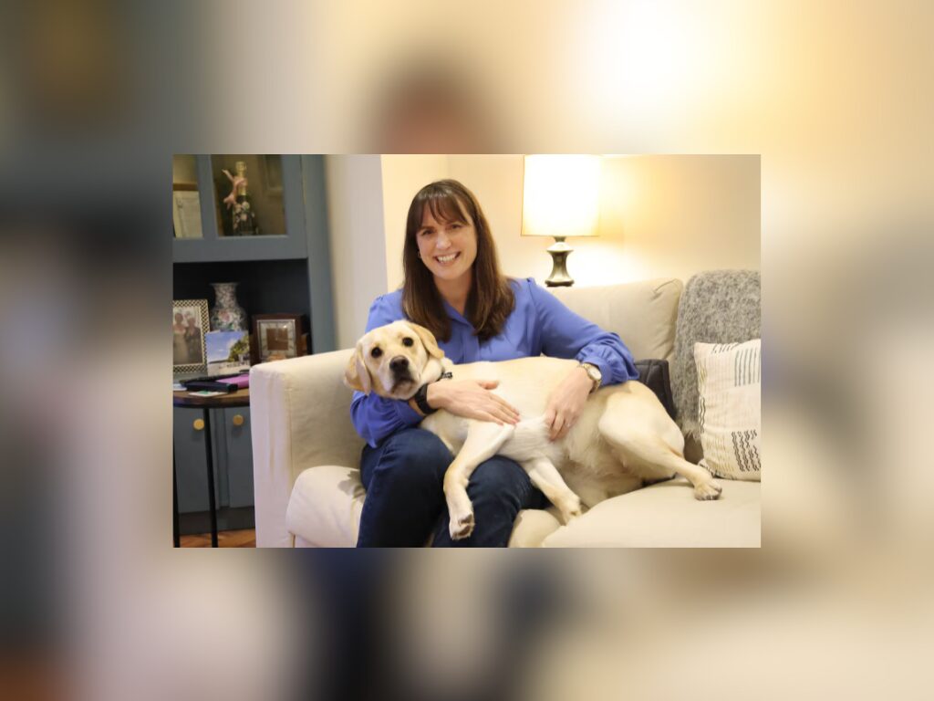woman sitting on couch with dog