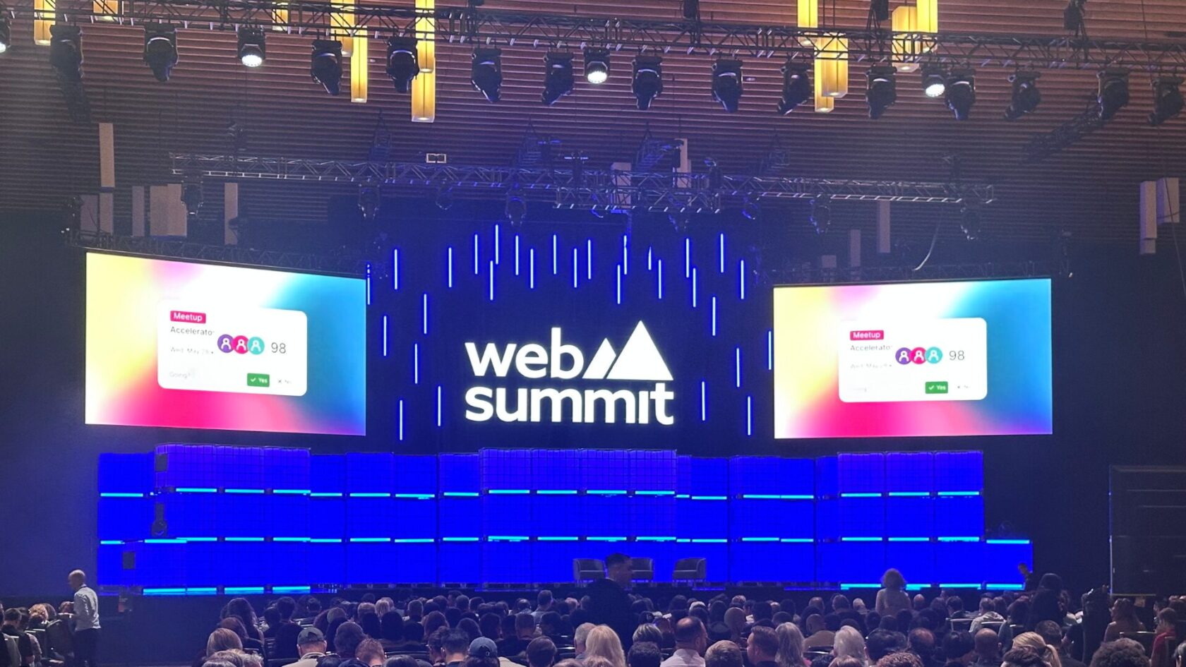 audience sitting in front of a presentation stage at a conference