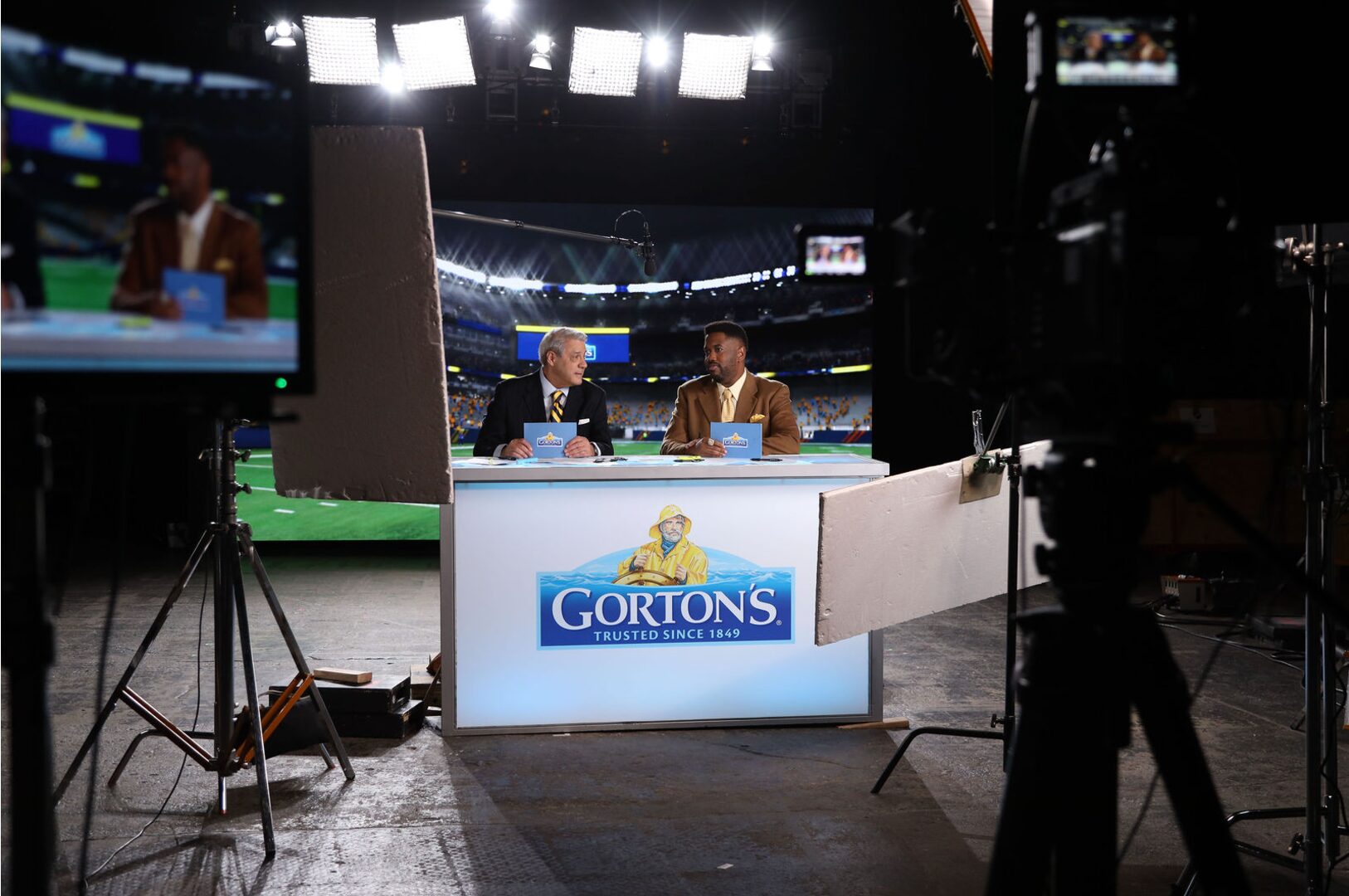 two sports anchors at a desk