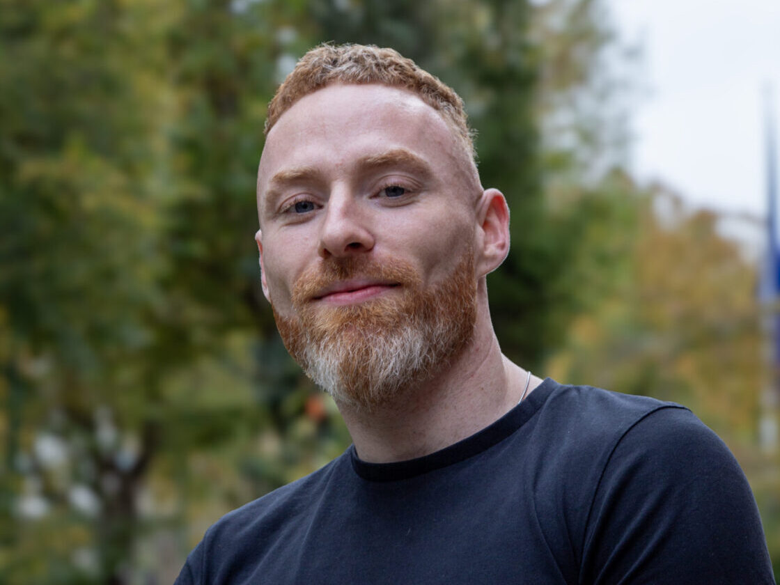 man in black shirt standing outside