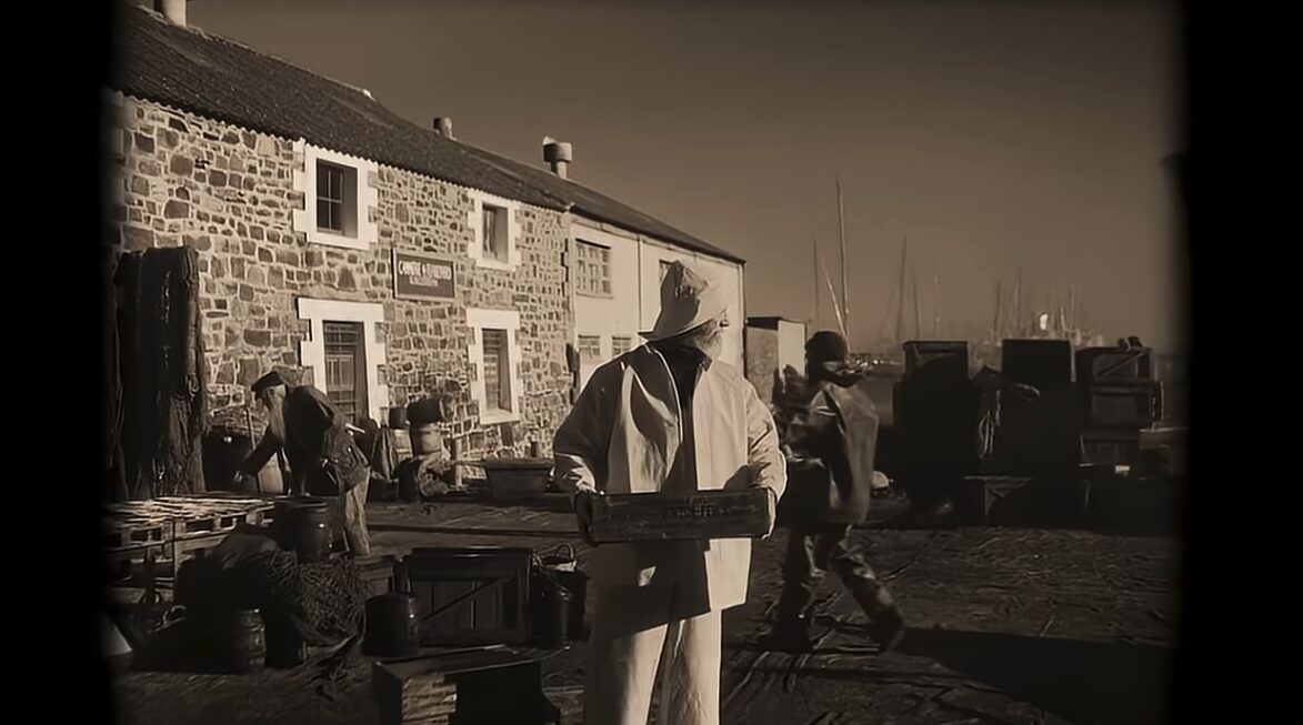 fisherman carrying a box on a pier